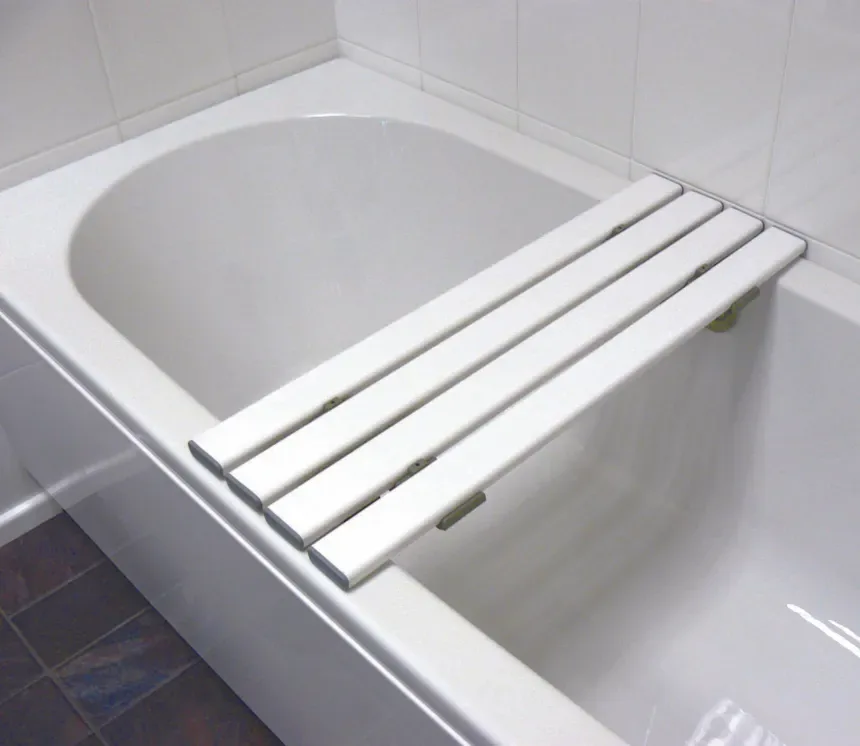 A slatted bath board fitted across the width of a domestic bath